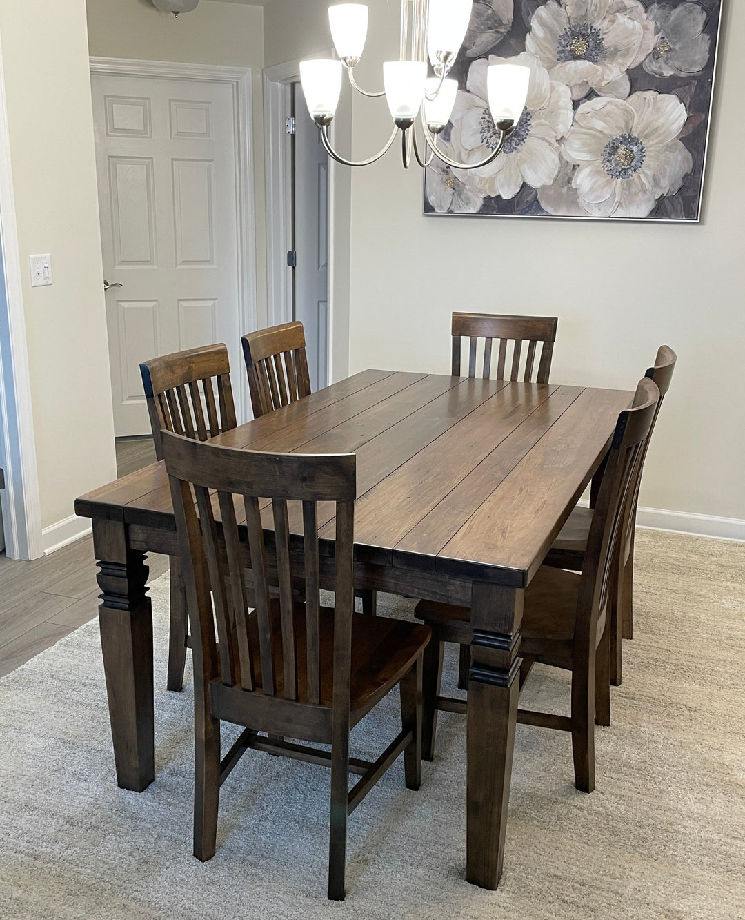 Dark stained dining table with slat-back chairs